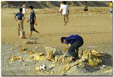 Boy with ball in rubble